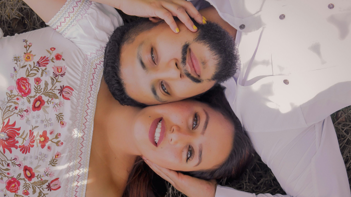 a man and woman laying on the ground with their arms around each other at The Brookbend