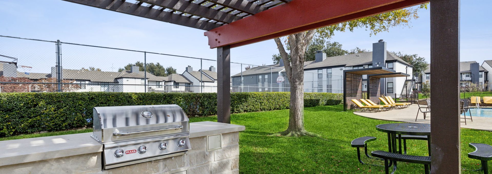 a grill and picnic table in the backyard of a house at The Brookbend