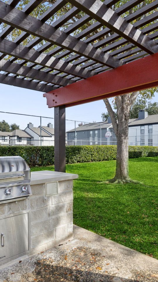 a grill and picnic table in the backyard of a house at The Brookbend