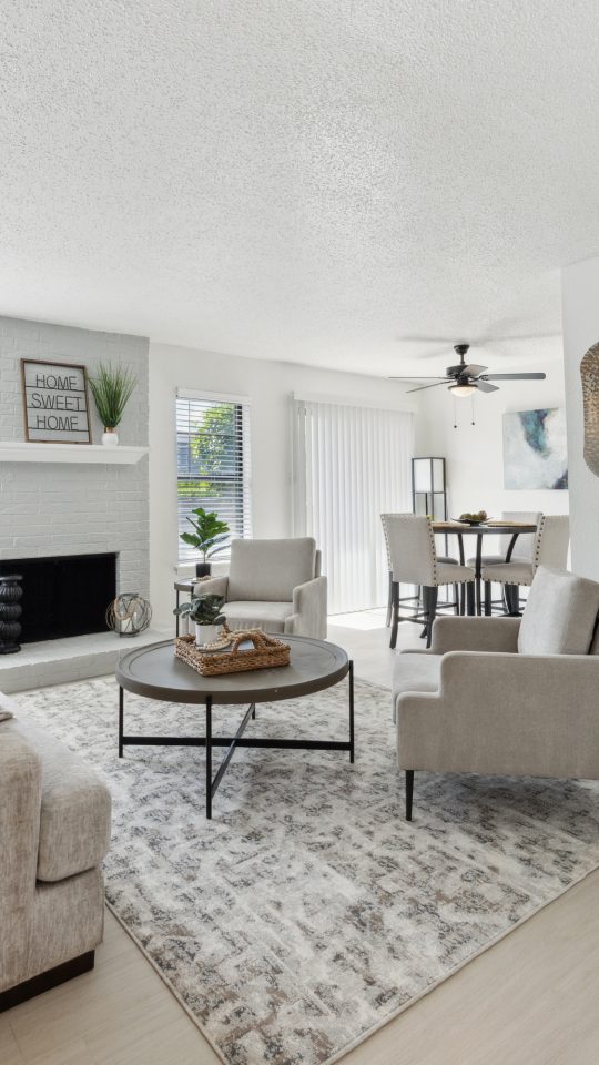 a living room with white walls and a fireplace at The Brookbend